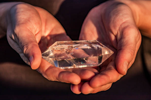istock Hands Holding a Beautiful Terminated Quartz Crystal 993438046