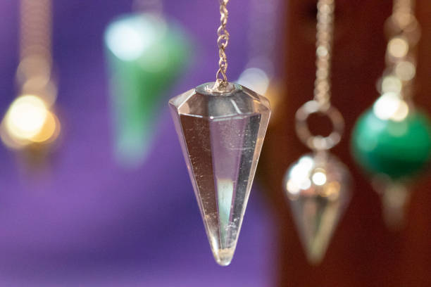 Several Beautiful Crystal Pendulums Several Beautiful Crystal Pendulums. chakra recovery energy gem stock pictures, royalty-free photos & images