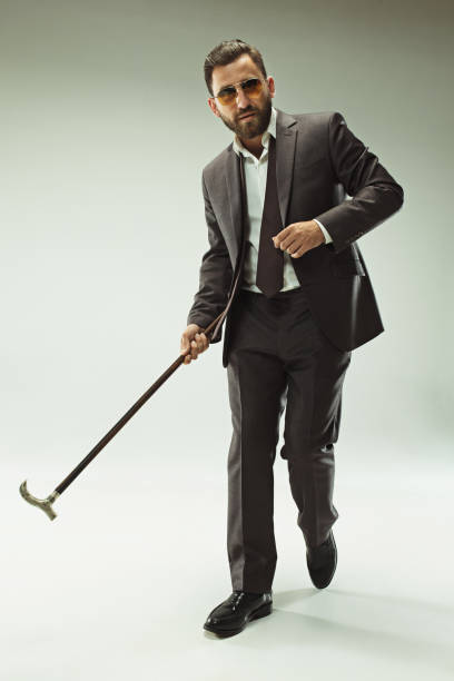 istock The barded man in a suit holding cane 993438376