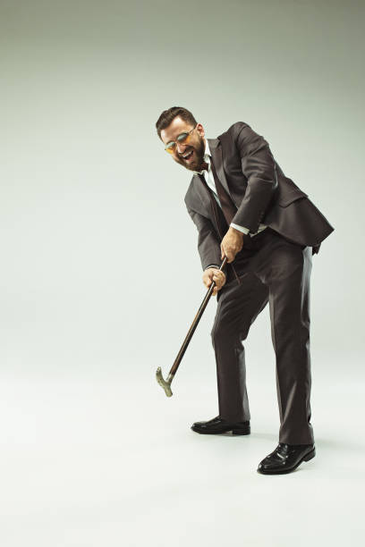 istock The barded man in a suit holding cane 993438532