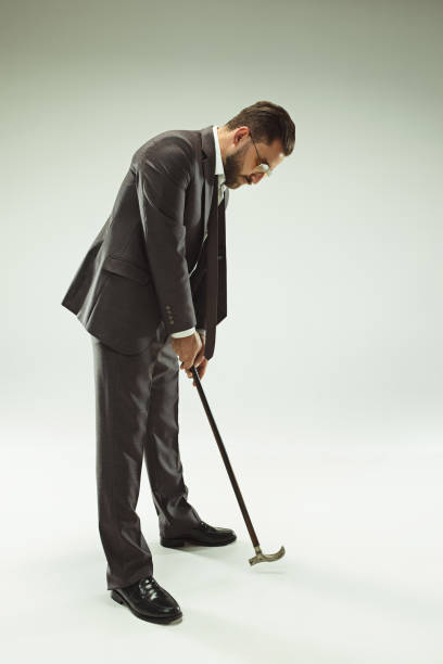 istock The barded man in a suit holding cane 993438810