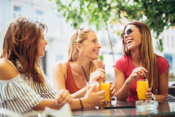 istock Three beautiful friends in a cafe having fun 993439204