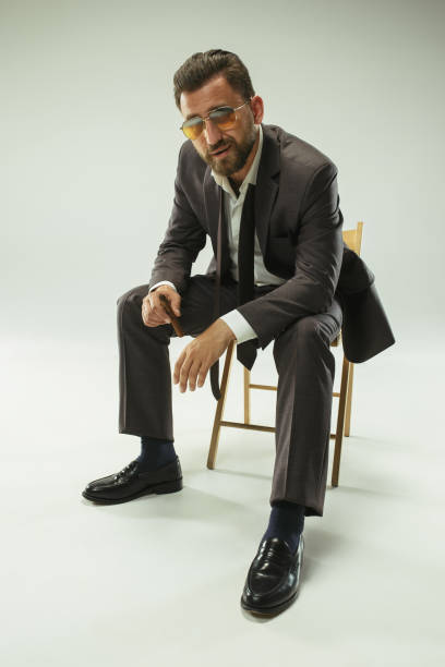 istock The barded man in a suit holding cigar 993445712