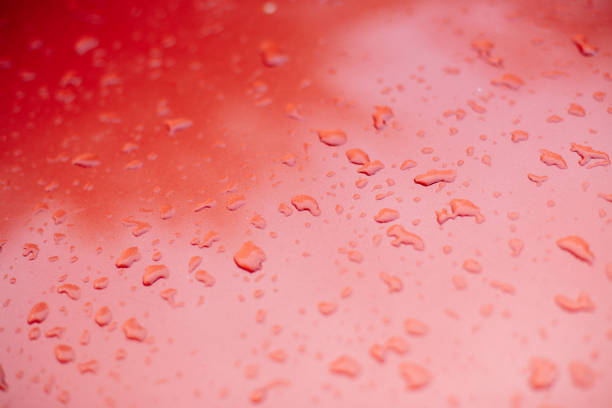 istock Drops of water on a glossy surface 993453258