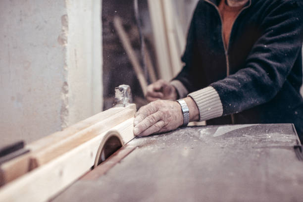 istock The carpenter works on a woodworking machine. 993454844