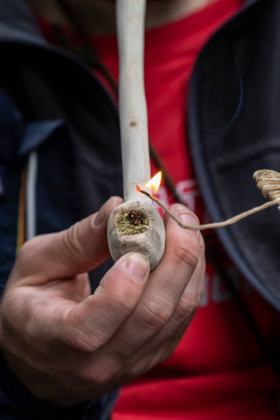 istock Someone Smoking Marijuana out of a Hand Carved Pipe 993462240