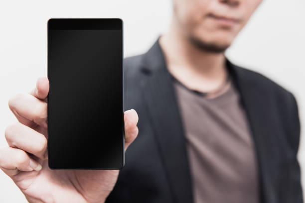 Businessman hand holding show smartphone empty screen with clipping path at display