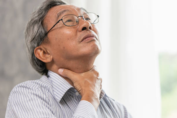 istock elderly sore throat irritation hand massage squeeze at neck 993463262