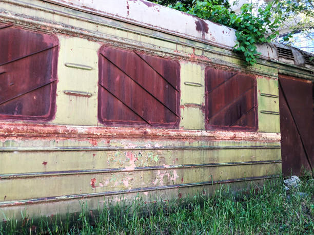 istock Abandoned train. Forgotten overgrown railway. Old rusty railway carriage 993463454
