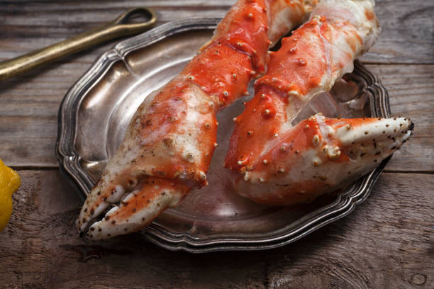 istock Fresh crab claws on vintage wooden background. Composition with copy space 993466446