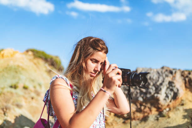 istock Girl holding digital camera 993472452