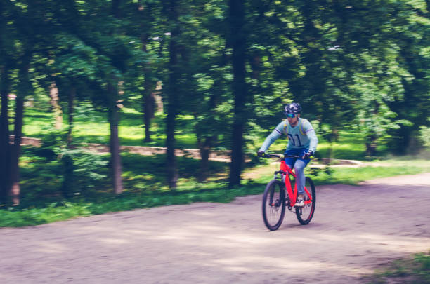 istock A cyclist in a helmet rides a bicycle path, motion blur 993472492