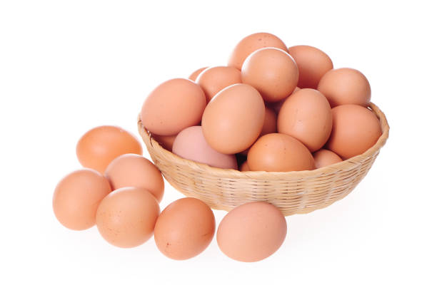 istock Basket with eggs in front of white background 993473750