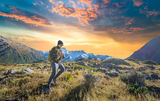 Young traveler taking photo at mt cook famaus destination in new zealand