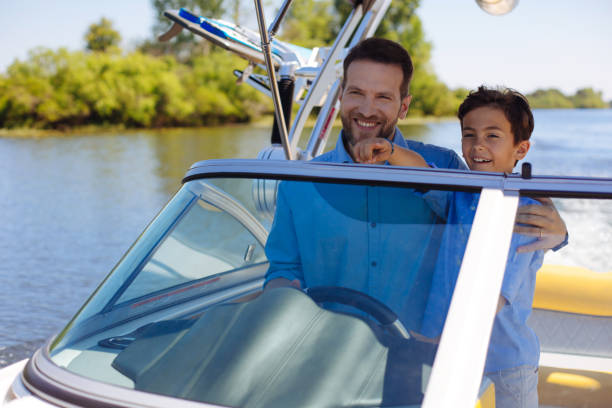 istock Happy man and his son sailing the yacht 993478812