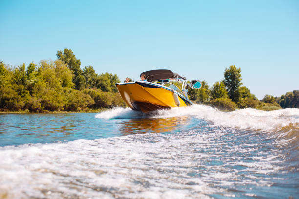 istock Happy family sailing a motorboat down the river 993481130