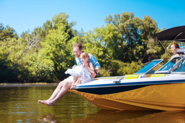 istock Happy father and daughter observing fish while sitting on boat 993481484