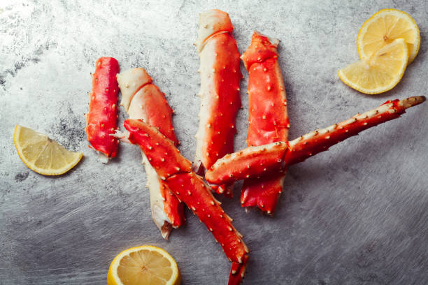 istock Cooked crab phalanx with lemon on metallic background. Top view with copy space. 993486622