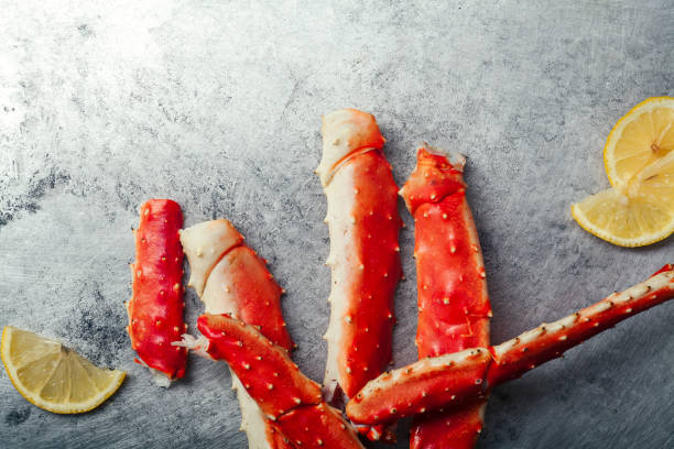 istock Cooked crab phalanx with lemon on metallic background. Top view with copy space. 993486648
