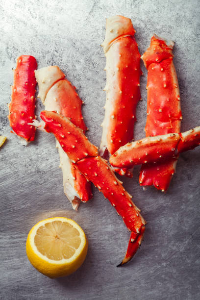 istock Cooked crab phalanx with lemon on metallic background. Top view with copy space. 993486652