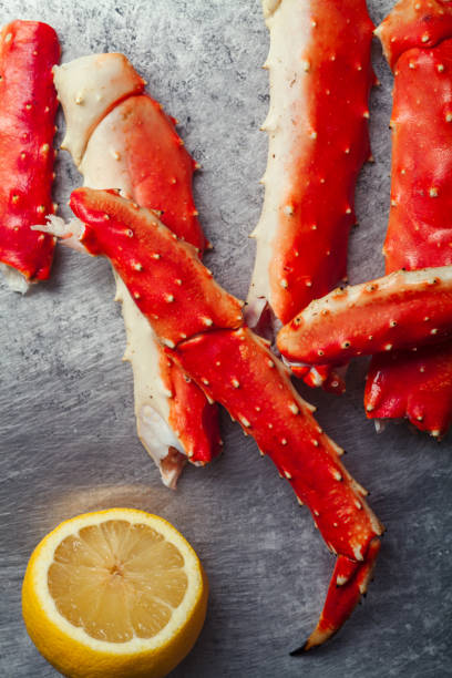 istock Cooked crab phalanx with lemon on metallic background. Top view with copy space. 993486686