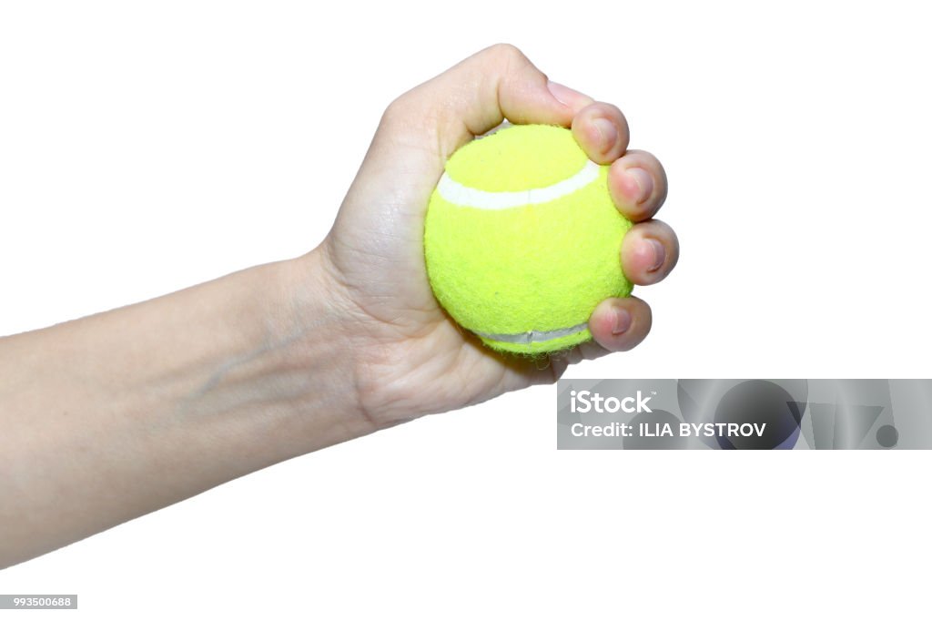 tennis ball in hand against white background Exercising Stock Photo