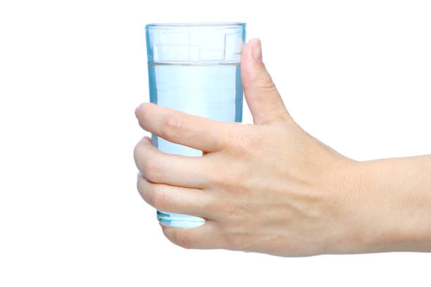 istock hand with a glass of water against white background 993500726