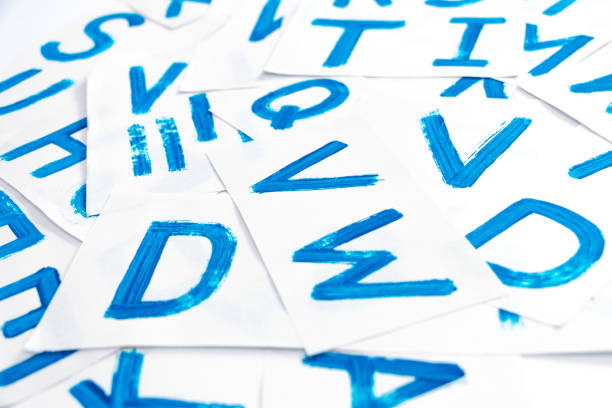 istock Alphabet drawing. Process of creating watercolor font. Background with blue colored letters. 993503268
