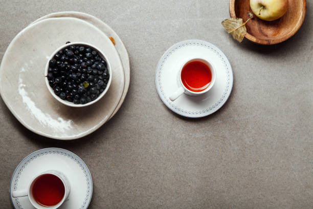 Tea cups and pie filling ingredients. Concrete rustic background. Space for text.
