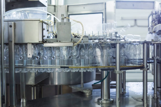 istock Water factory - Water bottling line for processing and bottling pure spring water into small bottles 993523950