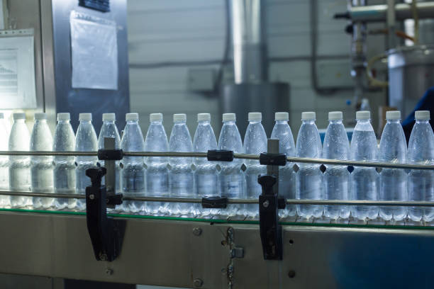 istock Water factory - Water bottling line for processing and bottling pure spring water into small bottles 993524546