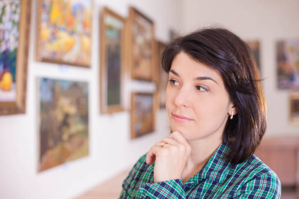 istock Young woman looking at painting. 993563124