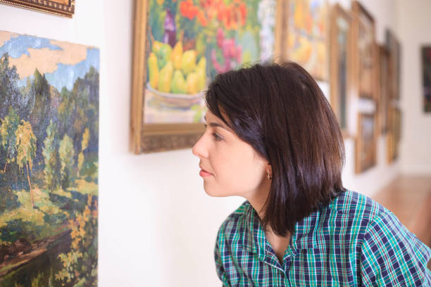 istock Young woman looking at painting. 993563248