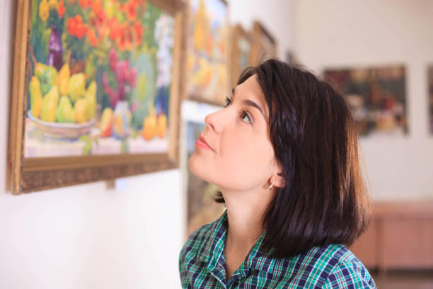 istock Young woman looking at painting. 993563684