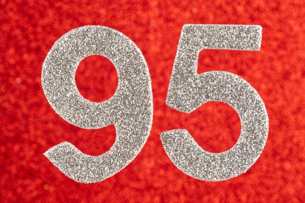 istock Number ninety-five silver color over a red background. Anniversary. 993568988
