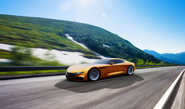 istock orange car driving on a mountain road 993570136
