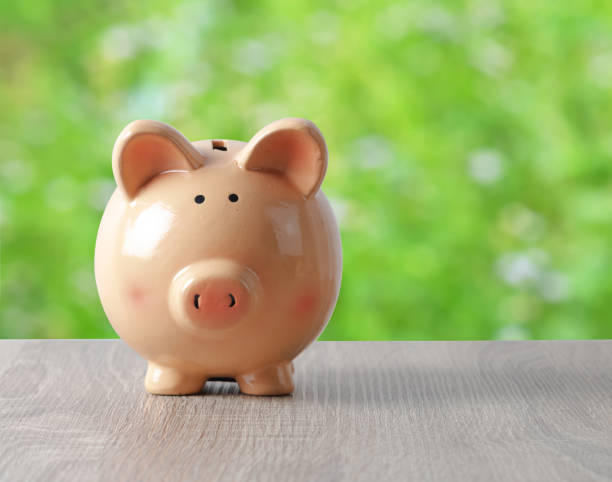 istock Piggy bank on the wooden table with copy sapce 993570148