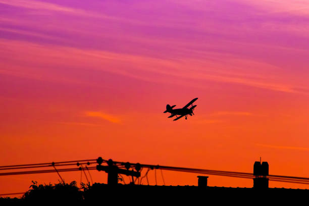 Biplane flying into the sunset