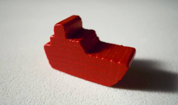 istock Red tiny wooden colorful boat closeup on white background 993578430