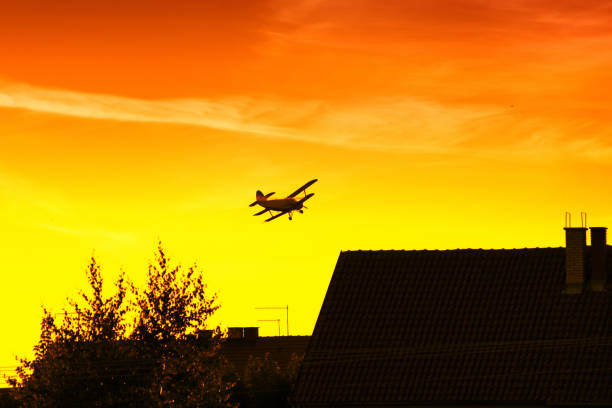 Buildings, sky and plane in flight high in the sky: concept of travel and vacation