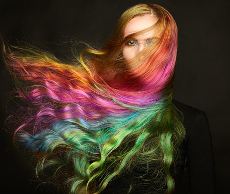 Portrait of young beautiful woman with long flowing hair. Model with perfect Healthy Dyed Hair. Rainbow Hairstyles