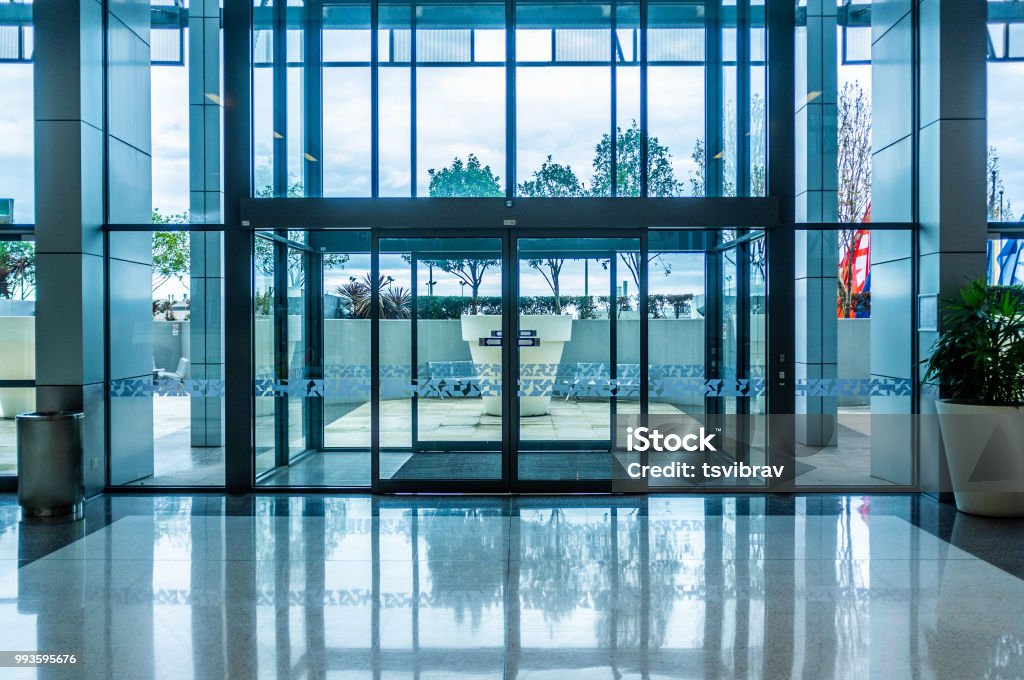 Glass automatic sliding doors entrance into shopping mall Door Stock Photo