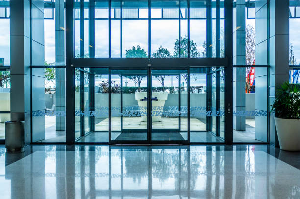 Glass automatic sliding doors entrance into shopping mall stock photo