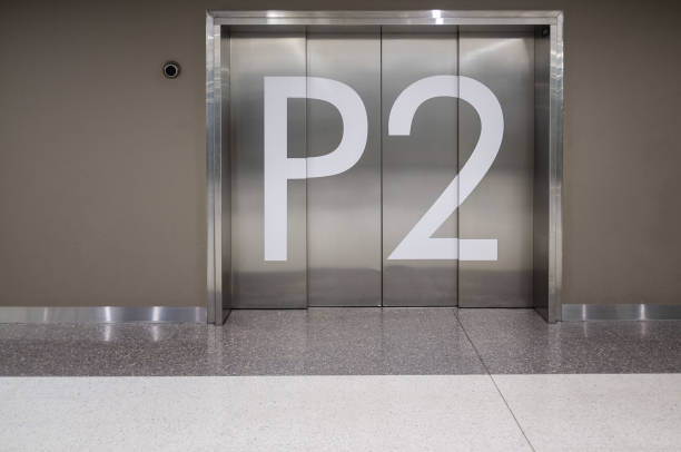 istock Elevator doors on parking underground level 2 floor of public building 993596824
