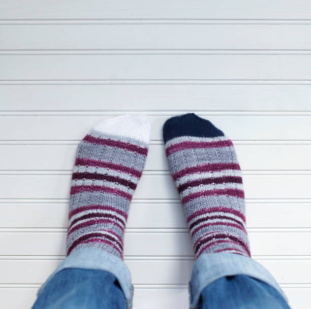 istock Pair of feet wearing striped socks 993598246