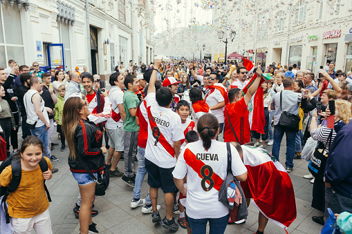 Moscow, Russia - July 3 2018: Peruvian fans marching along the Nikolskaya Street in the centre of Moscow during the 2018 World Cup in Russia