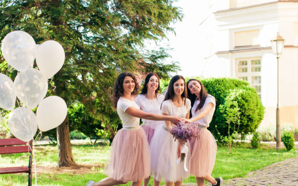 istock Bride with friends in the summer park 993608284
