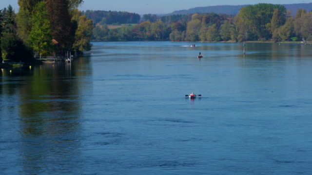 A man sails along the river Rhine in a kayak, Stein am Rhein, Switzerland