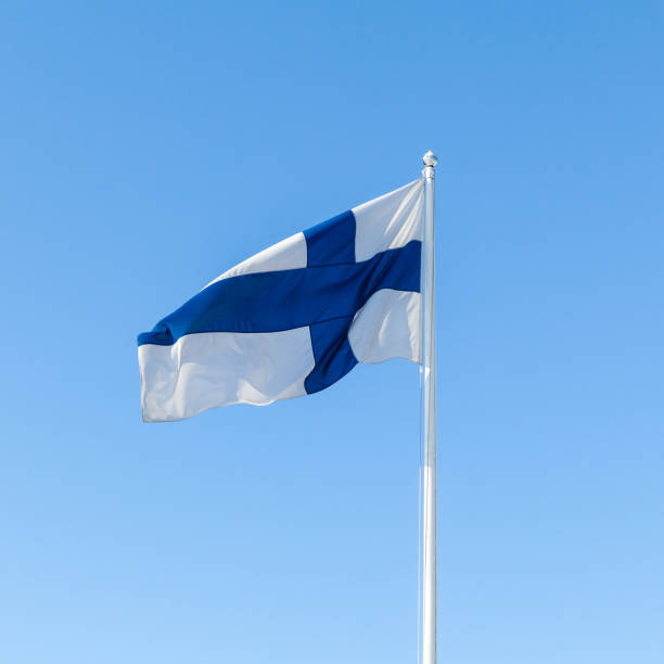 istock Flag of Finland waving over blue sky 993616160