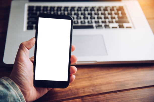 istock hands business holding blank screen mobile in desk work. 993618488